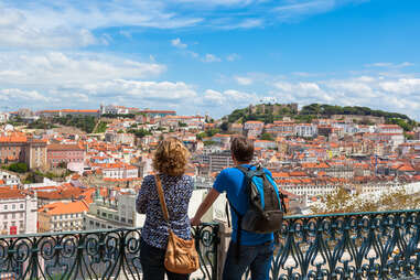 two people looking out from sao pedro de alcantara viewpoint, lisbon 