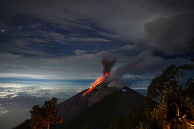 Erupting volcano and night sky